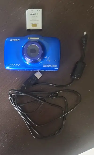 Capture life's moments with the Blue Nikon COOLPIX S32, a digital camera designed to go wherever you...