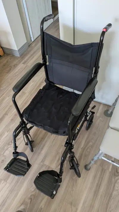 Transport Wheelchair Cushioned armrests and swing away footrests Folds easily for transporting