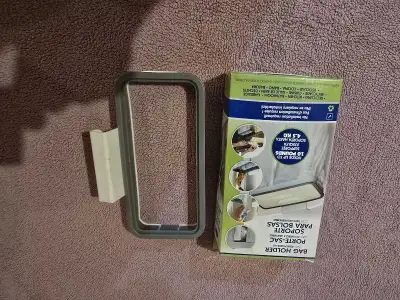 Selling 2 garbage bag holders that go over cabinet. 1 is new in box and the other was tried but neve...