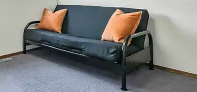 This futon is perfect for a small space or spare room, featuring a black metal frame and comfortable...