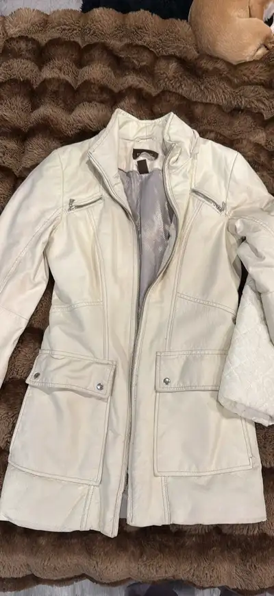 This is a T Tahari jacket, perfect for adding a touch of sophistication to any outfit, featuring a z...