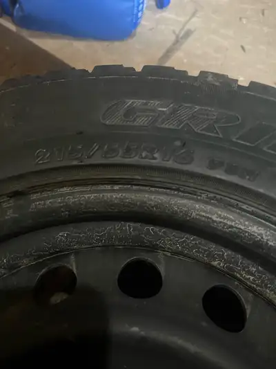Durable 215/55R16 winter tires are mounted on black steel rims. The set has a 5-bolt pattern. The tr...