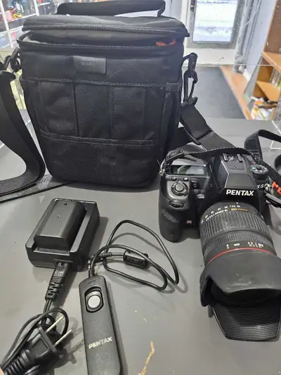 I'm selling a Pentax K-5 digital SLR camera, complete with a Sigma 18-200mm lens, offering a versati...