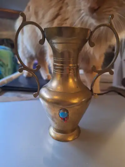 This vintage brass urn is a unique piece with embedded turquoise and coral accents, showcasing an el...