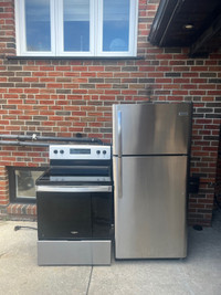 ALMOST new stainless steel fridge and glass top stove set 