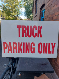 Steel truck parking only sign.
