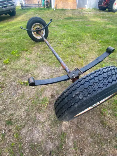 2000 lb trailer axle, leave springs and wheels. All brand new from a project that never happened.