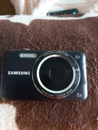 Capture memories with this used Samsung ES73 12.2 mega pixel digital camera featuring a 5x zoom lens...