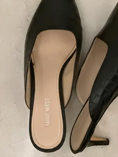 Step out in style with these Nine West black heels, size 9M! These stylish mules feature a chic, poi...