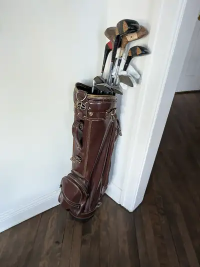 Mixed vintage clubs (MacGregor, Callaway, Wilson, etc.) with classic leather bag. Great for collecto...