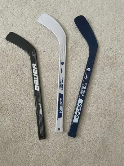 Get ready to hit the ice with these used hockey sticks, including a Bauer ONE and two Toronto Maple...
