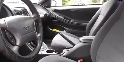 This 1999 Ford Mustang is a classic used sports car that is ready for a new owner. It features a vib...