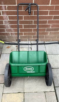 Lawn care seed and fertilizer spreader