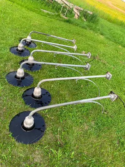 Set of 6 black and white porcelain shaded clamshell service station lights and brackets. Various deg...