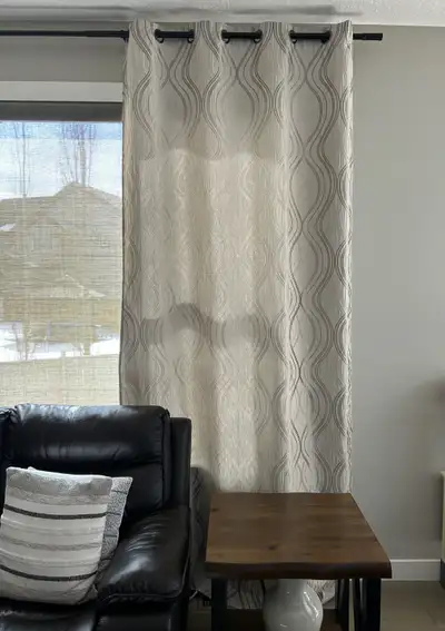 2 like new ivory/gold curtain panels. 80% blackout curtains. Each panel measures 106" in length and...