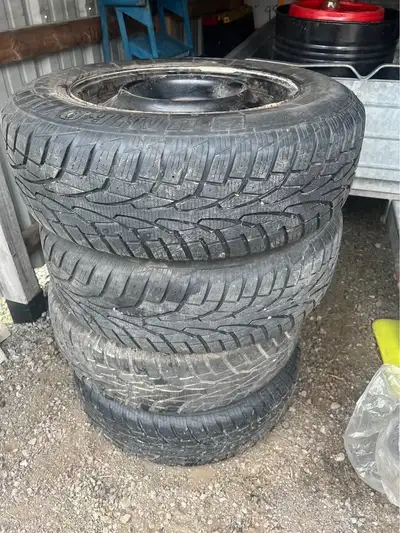 Set of winter tires 215/70R16 good condition on Nissan Rogue rims with set of hub caps also have a s...