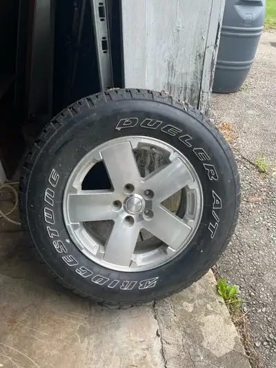 Selling a Jeep tire and rim, size P255/70R18. This wheel is in fair condition, showing some wear and...