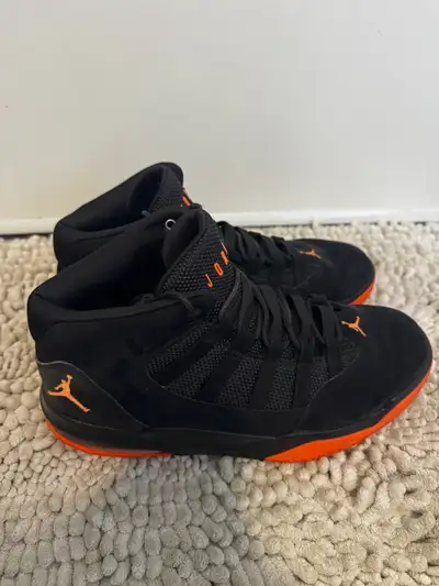 Get ready to elevate your game with these Jordan basketball shoes, designed in a sleek black and vib...