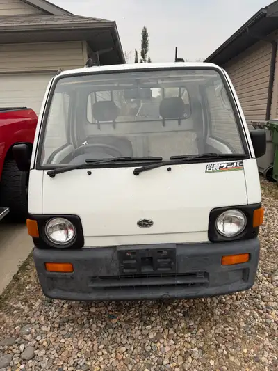 1992 Subaru Sambar 4cyl 660cc rear mount engine. Needs seat covers and the fuel gauge works intermit...