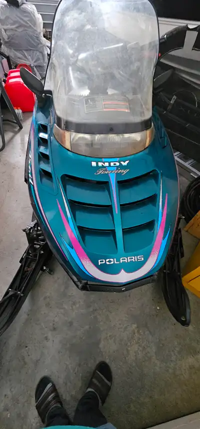 Two identicle 1998 Polaris Indy Trail Touring snowmobiles (low Km's) featuring a 488cc twin-cylinder...