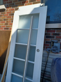 Wood door with glass panels adapted to use as barn door.