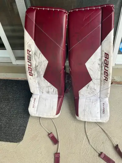 30 plus 1 inch maroon and white Bauer SV Pro goalie pads., View more