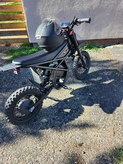 Get ready for off-road excitement with this used Riding Times electric dirtbike, featuring a durable...