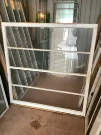 Vintage wood window with clear glass and exterior grills