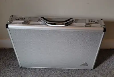 Briefcase aluminum with silver finish. You can set your own password on the locks $5