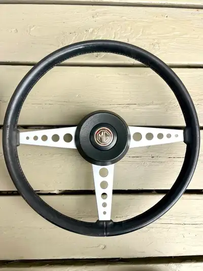 Original 15” MGB steering wheel complete with hub and centre motif or horn button. Spokes stripped a...