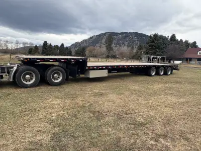 2015 Doepker step deck with ramps 53’ tridem air ride 2 storage boxes and dunnage rack Safety good t...