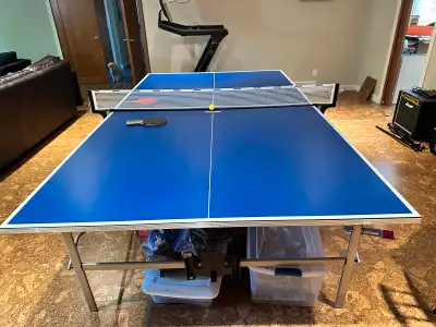Like new, foldable Kettler ping pong table with four paddles and balls.