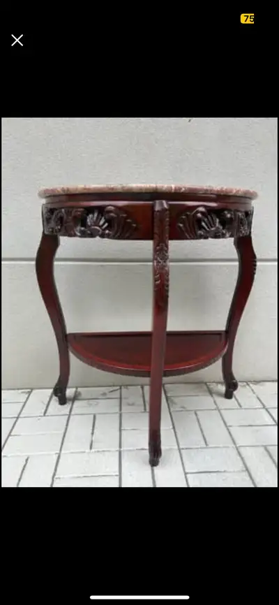 Add a touch of elegance to your home with this beautiful used marble top table! It features a unique...