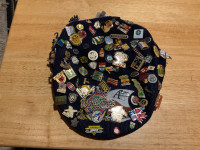 Large pin collection on an antique Argos cap
