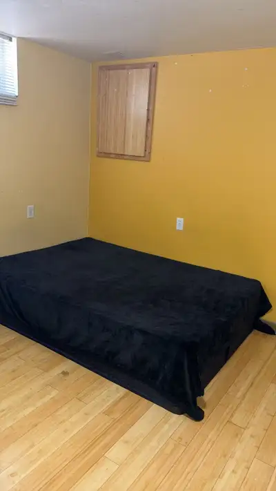One furnished room with bed is available in a clean 2-bedroom walk-in basement, very close to Square...