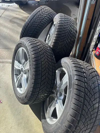 I'm selling a set of four Goodyear UltraGrip winter tires mounted on Ford aluminum rims, size 235/55...