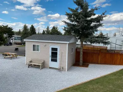 Beautifully landscaped RV lot backing onto the green space at Country Lane Estates RV Park in Alders...
