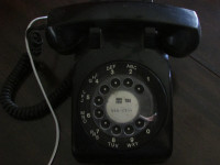 Black rotary dial telephone. Works