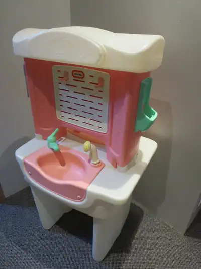 Quality Little Tikes Beauty Salon that has a sink, tap, sprayer, mirror, hooks, and drawer. A little...