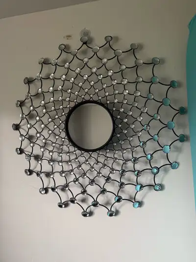 Beautiful wall mirror with black metal frame and crystal-style details. Good condition.
