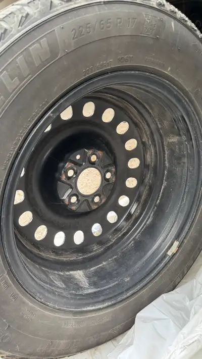 I'm selling a used Michelin X-Ice Snow SUV tire, size 225/65R17, mounted on a steel rim, perfect for...