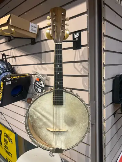 This vintage Vega Little Wonder banjo mandolin is a classic piece with a rich history and distinct c...