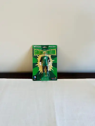 Embrace the brilliance of the Green Lantern with this poseable/bendable figurine, a must-have for fa...