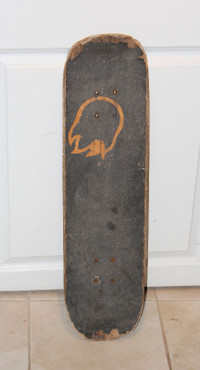 Road worn standard popsicle skateboard deck with grip cover.
