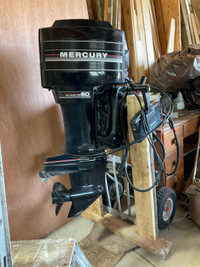 60 hp Mercury outboard with controls and fuel tank. 