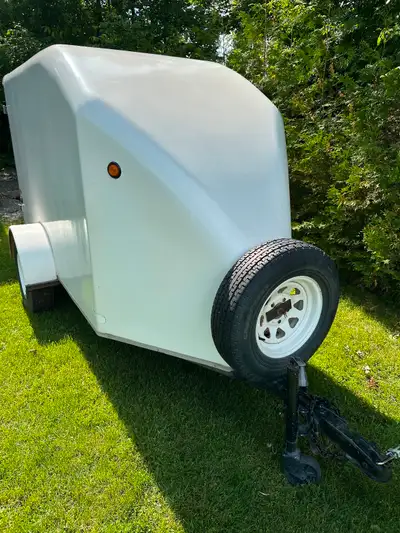 White light narrow fiberglass covered trailer. 48” wide X 53” high X 10’ long including v-nose. Barn...