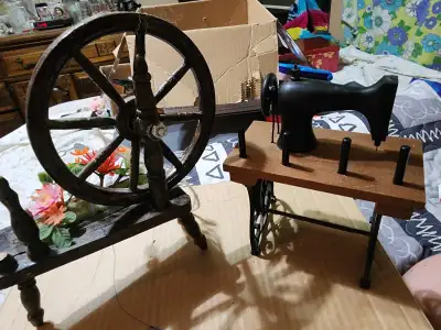 I'm offering a charming set of miniature decorative items, featuring a spinning wheel and a sewing m...
