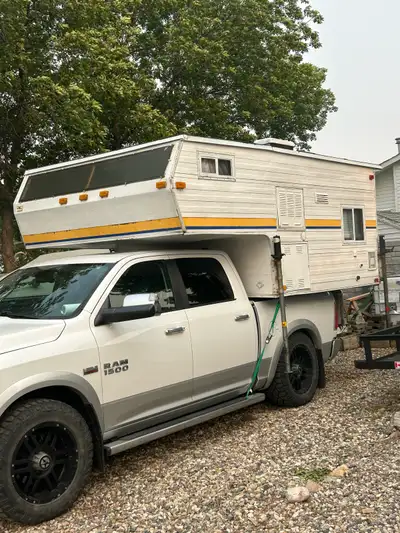 8’ camper I am selling a used truck camper featuring essential appliances, a sleeping area, and a co...