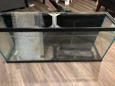 55 gallon aquarium with home made stand. Some execories. The glass is not in very good shape. Some s...