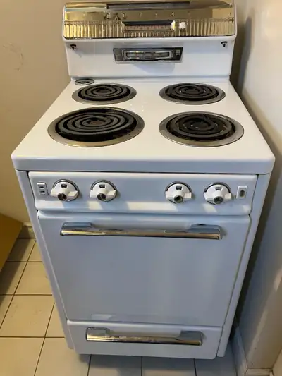 This is a vintage Moffat electric stove with four coil elements on top and a standard oven. It's an...